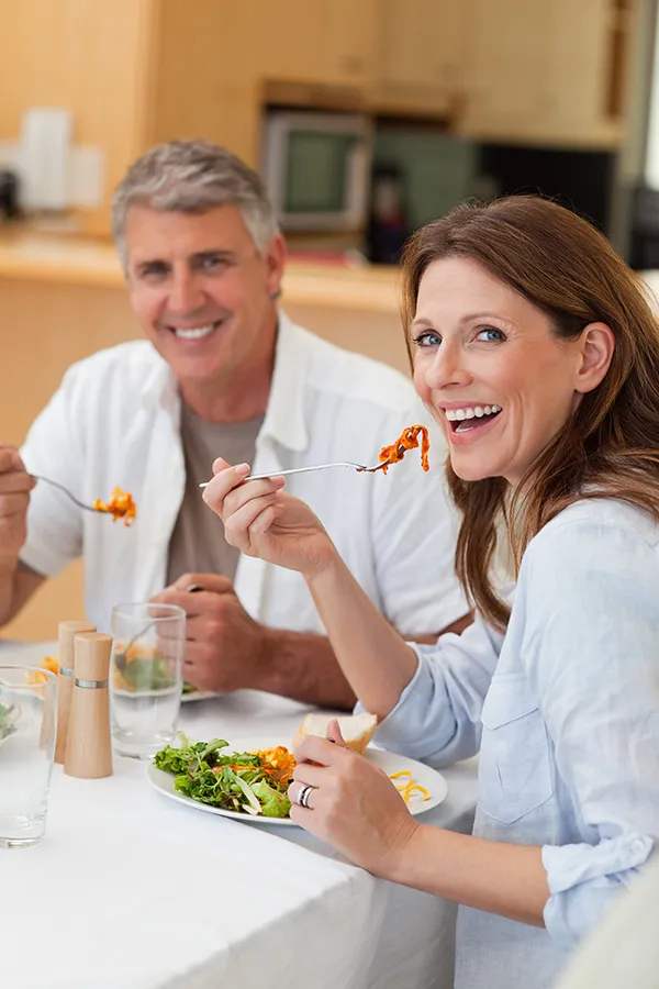 Micronutrient-Testing-Treatments A middle-aged couple eat a healthy meal. Get micronutrient testing from Richard Conlen, MD, FACOG in Boca Raton.