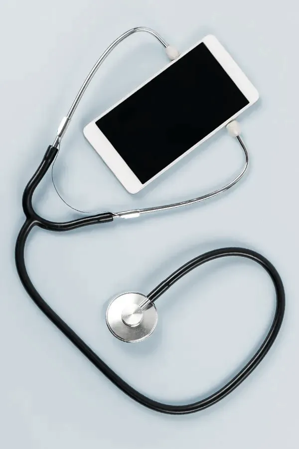 A smartphone with a stethoscope attached to it, symbolizing Telemedicine treatment from Richard Conlen, MD, FACOG in Boca Raton.